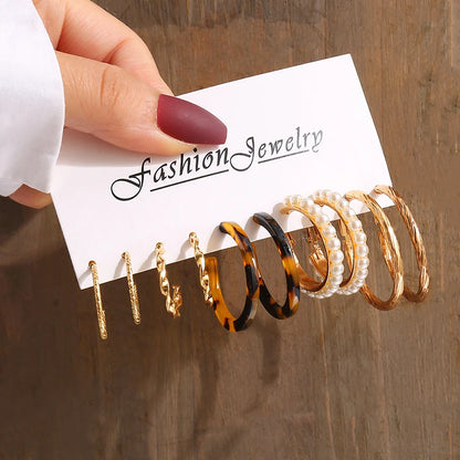 Gold geometric pearl earrings, trendy and party-ready.